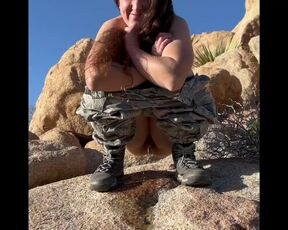 Girl peeing outdoors In desert